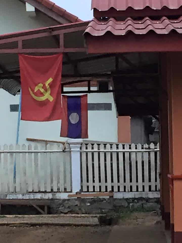 This outdoor gathering place looks like a Townhall. I noticed right away the communist flag and the Lao flag both flying.