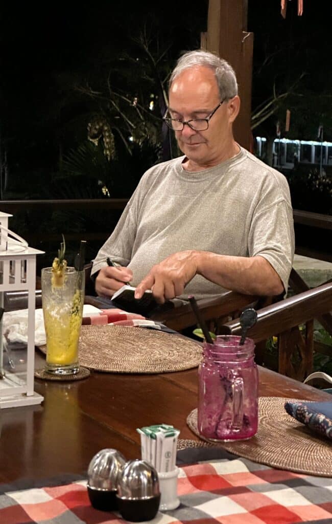 Writing even at the dinner table. Photo by Laura Davis.